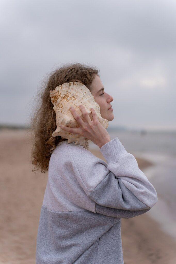woman, conch shell, beach-8261342.jpg