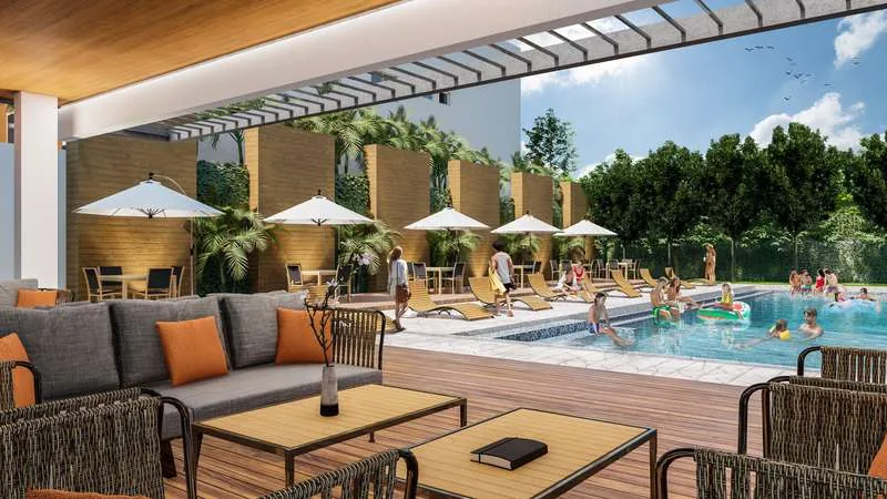 Área social con piscina, sombrillas y lounge de Julio Adriano Residences