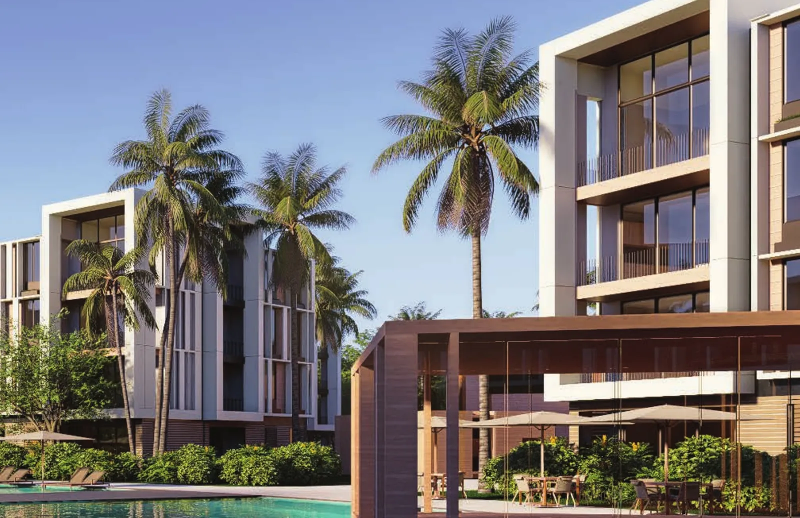 Edificios residenciales y piscina con pérgola en Distrito Playa Juan Dolio