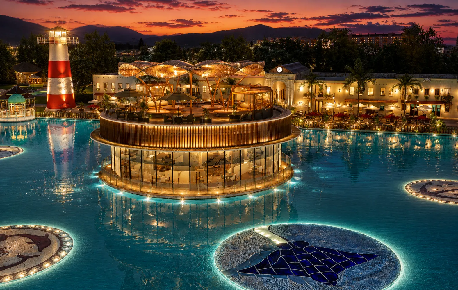 Gran lago interactivo de Cruise On Land Punta Cana de noche, con el restaurante iluminado